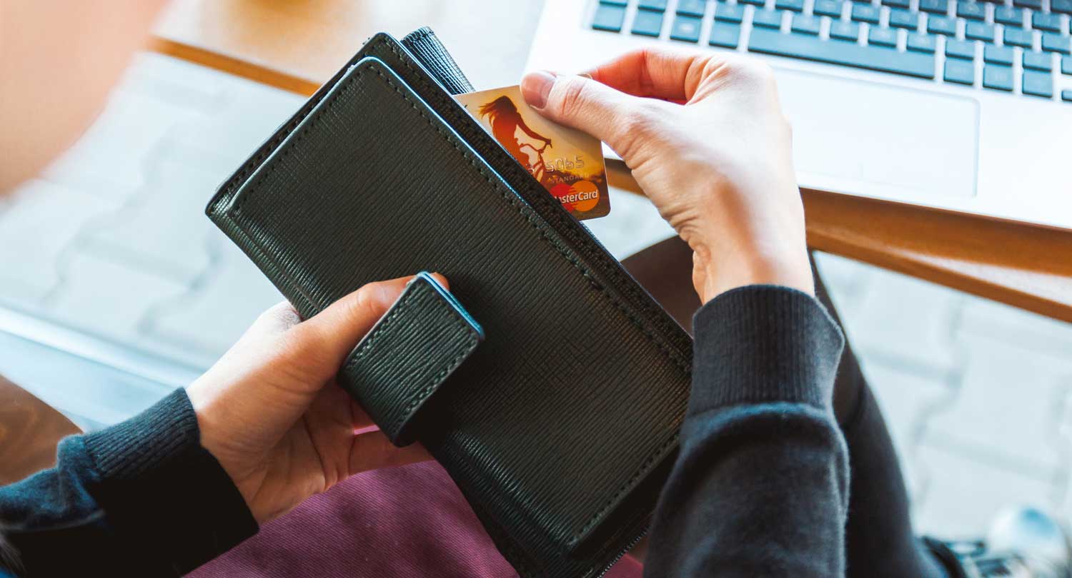 ecommerce shopper getting debit card out of wallet