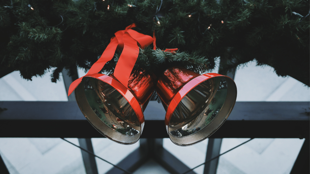 two red Christmas bells attached to wreath